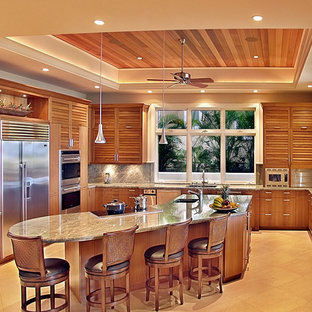 This is an example of a large contemporary u-shaped kitchen in Hawaii with an undermount sink, louvered cabinets, medium wood cabinets, granite benchtops, grey splashback, stone slab splashback, stainless steel appliances and with island.