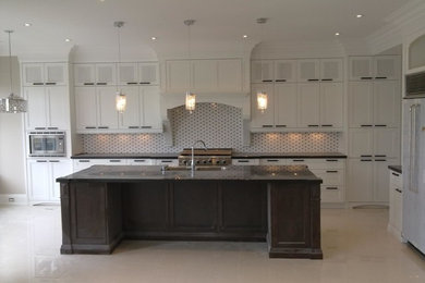Trendy galley eat-in kitchen photo in DC Metro with a double-bowl sink, flat-panel cabinets, white cabinets, granite countertops, multicolored backsplash, ceramic backsplash, stainless steel appliances and an island