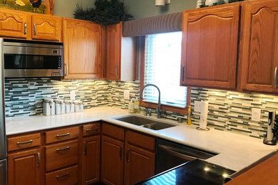 Example of an eat-in kitchen design in Other with green backsplash and mosaic tile backsplash