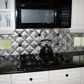 Kitchen Backsplash- Stainless steel and black granite accents. Black granite