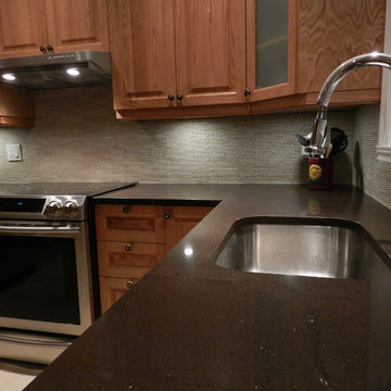 Kitchen backsplash with marble mosaic & counter top with brown quartz