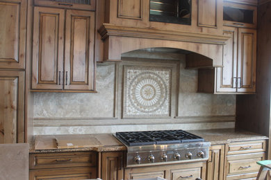 Inspiration for a mid-sized rustic u-shaped travertine floor kitchen remodel in Vancouver with beige backsplash and stone tile backsplash
