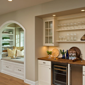 Kitchen Bar with Antique White Cabinets and Wood Countertop