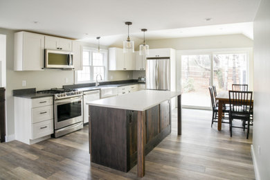 Inspiration for a transitional kitchen remodel in Boston with a farmhouse sink, shaker cabinets and an island