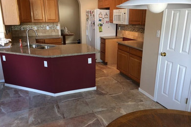 This is an example of a contemporary kitchen in Albuquerque with porcelain splashback and porcelain flooring.
