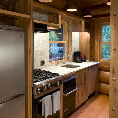Mountain style single-wall enclosed kitchen photo in Minneapolis with a single-bowl sink and stainless steel appliances