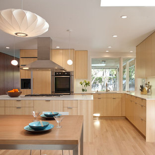 Modern open concept kitchen pictures - Minimalist l-shaped open concept kitchen photo in San Francisco with stainless steel appliances, an undermount sink, flat-panel cabinets, medium tone wood cabinets, quartz countertops and white backsplash