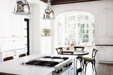 Eat-in kitchen - large transitional medium tone wood floor eat-in kitchen idea in Atlanta with white cabinets, shaker cabinets, stainless steel appliances and an island