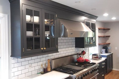 Kitchen photo in Philadelphia with gray cabinets, quartzite countertops and subway tile backsplash