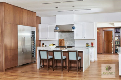 Example of a large 1960s u-shaped eat-in kitchen design in Los Angeles with shaker cabinets, white cabinets, marble countertops, white backsplash, an island and multicolored countertops