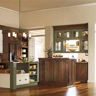 This is an example of a traditional single-wall kitchen/diner in Orange County with shaker cabinets, dark wood cabinets, beige splashback, ceramic splashback, medium hardwood flooring and multiple islands.