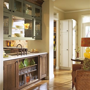 Design ideas for a traditional single-wall kitchen/diner in Orange County with dark wood cabinets, beige splashback, ceramic splashback, medium hardwood flooring and multiple islands.