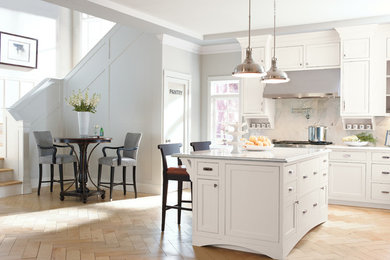 Inspiration for a large contemporary l-shaped open plan kitchen in Boston with recessed-panel cabinets, white cabinets, grey splashback, stainless steel appliances, an island, a belfast sink, quartz worktops, porcelain splashback and terracotta flooring.