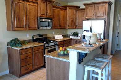 Example of a classic l-shaped eat-in kitchen design in Salt Lake City with raised-panel cabinets, medium tone wood cabinets and an island