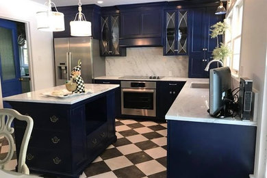 Inspiration for a medium sized victorian l-shaped kitchen/diner in New Orleans with a submerged sink, white splashback, stone slab splashback, stainless steel appliances, multi-coloured floors, white worktops, recessed-panel cabinets, blue cabinets, quartz worktops and an island.