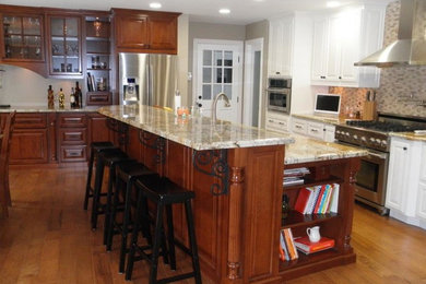 Open concept kitchen - eclectic l-shaped open concept kitchen idea in Las Vegas with raised-panel cabinets, white cabinets, quartzite countertops, beige backsplash and stainless steel appliances