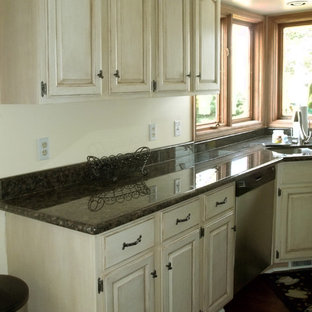 Large shabby-chic style galley kitchen pantry in Cleveland with a double-bowl sink, recessed-panel cabinets, medium wood cabinets, granite benchtops, black appliances, dark hardwood floors and with island.