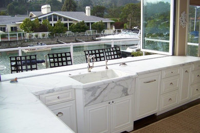 Classic kitchen in San Francisco with raised-panel cabinets, an integrated sink and marble worktops.