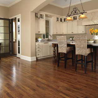Design ideas for a mid-sized transitional l-shaped open plan kitchen in Manchester with beige cabinets, granite benchtops, beige splashback, with island, vinyl floors, shaker cabinets and panelled appliances.