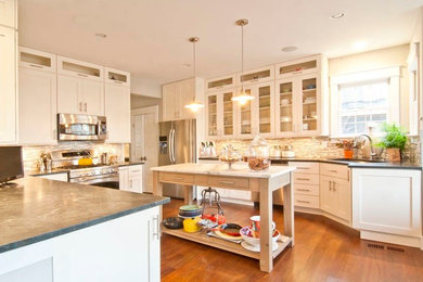 Large transitional medium tone wood floor kitchen photo in DC Metro with shaker cabinets, white cabinets, granite countertops, an island, an undermount sink, multicolored backsplash, matchstick tile backsplash and stainless steel appliances