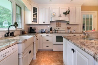 This is an example of a medium sized contemporary kitchen/diner in Boston with stainless steel appliances and an island.