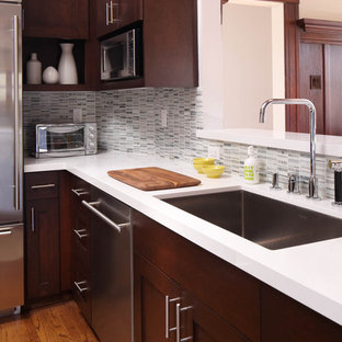 Contemporary kitchen appliance - Trendy kitchen photo in San Francisco with stainless steel appliances, an undermount sink, shaker cabinets, dark wood cabinets, quartz countertops, white backsplash and stone tile backsplash
