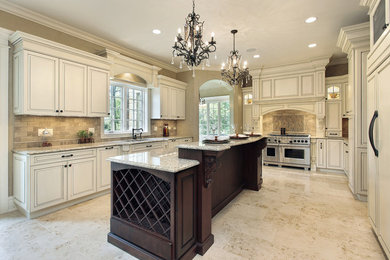 Inspiration for a large timeless u-shaped kitchen remodel in Boston with raised-panel cabinets, white cabinets, granite countertops, stainless steel appliances and an island