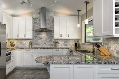 Mid-sized trendy u-shaped marble floor and gray floor open concept kitchen photo in Other with an undermount sink, shaker cabinets, granite countertops, gray backsplash, marble backsplash, stainless steel appliances and a peninsula
