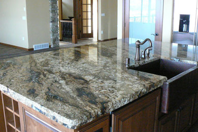 Example of a large farmhouse kitchen design in Seattle with granite countertops and an island