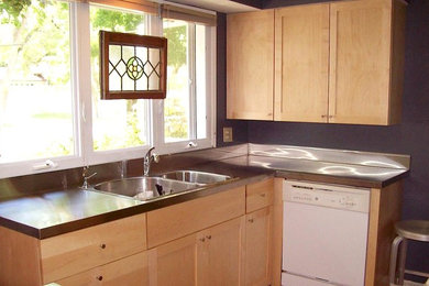 Inspiration for a mid-sized timeless l-shaped eat-in kitchen remodel in Grand Rapids with shaker cabinets, light wood cabinets, stainless steel countertops, white appliances, no island and a double-bowl sink