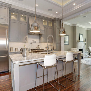 Inspiration for a timeless medium tone wood floor kitchen remodel in DC Metro with an undermount sink, gray cabinets, quartzite countertops and glass tile backsplash