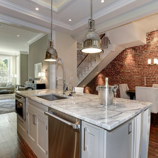 Example of a mid-sized classic medium tone wood floor kitchen design in DC Metro with an undermount sink, gray cabinets, glass tile backsplash, shaker cabinets, granite countertops and an island