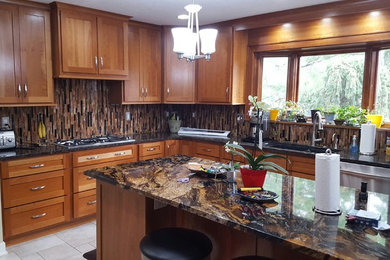 Enclosed kitchen - large traditional l-shaped porcelain tile enclosed kitchen idea in Chicago with a double-bowl sink, shaker cabinets, medium tone wood cabinets, granite countertops, brown backsplash, matchstick tile backsplash, stainless steel appliances and an island