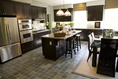 Example of a mid-sized minimalist l-shaped ceramic tile and gray floor eat-in kitchen design in Wilmington with dark wood cabinets, granite countertops, white backsplash, an island, an undermount sink, shaker cabinets, ceramic backsplash and stainless steel appliances