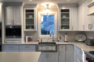 Eat-in kitchen - mid-sized transitional l-shaped porcelain tile and gray floor eat-in kitchen idea in New York with a farmhouse sink, white backsplash, porcelain backsplash and an island