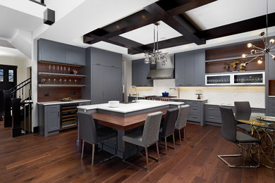 Inspiration for a mid-sized contemporary l-shaped medium tone wood floor eat-in kitchen remodel in Calgary with an island, a farmhouse sink, shaker cabinets, gray cabinets, quartzite countertops, white backsplash, stone slab backsplash and stainless steel appliances
