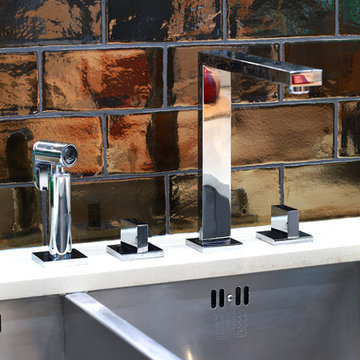Kitchen detail with feature bronze tile splashback