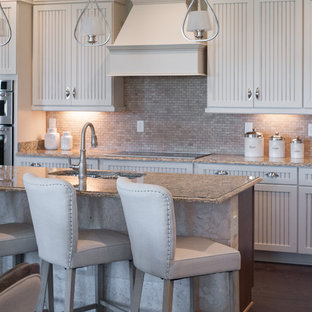 Mid-sized country single-wall eat-in kitchen in Jacksonville with a double-bowl sink, louvered cabinets, white cabinets, marble benchtops, beige splashback, stone tile splashback, stainless steel appliances, vinyl floors and with island.