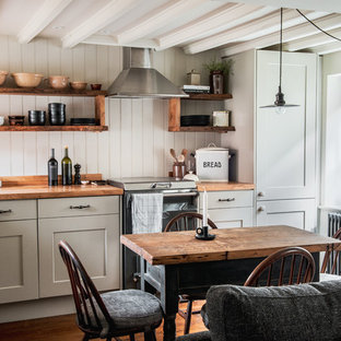 Design ideas for a small rural l-shaped kitchen/diner in Other with a belfast sink, wood worktops, medium hardwood flooring, shaker cabinets, brown floors, brown worktops and exposed beams.