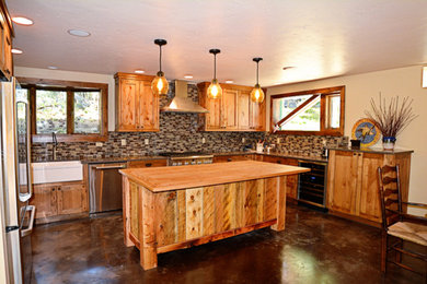 Example of an arts and crafts u-shaped eat-in kitchen design in Boise with a double-bowl sink, light wood cabinets, stainless steel appliances and an island