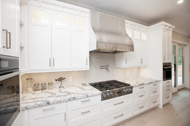 Kitchen - craftsman l-shaped light wood floor kitchen idea in Toronto with white cabinets, white backsplash, ceramic backsplash, stainless steel appliances and white countertops