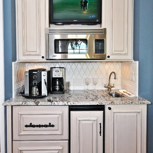 This is an example of a mediterranean kitchen in Other with granite benchtops, raised-panel cabinets and beige cabinets.