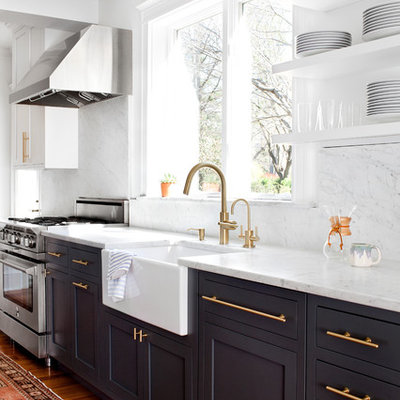 Transitional medium tone wood floor kitchen photo in Baltimore with a farmhouse sink, shaker cabinets, black cabinets, marble countertops, stainless steel appliances, marble backsplash and white countertops