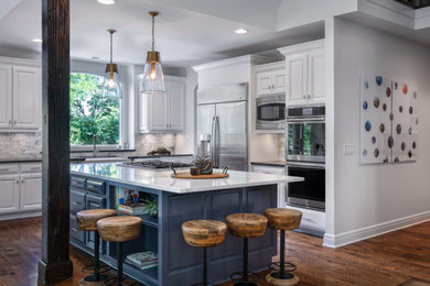 Example of a large l-shaped medium tone wood floor eat-in kitchen design with raised-panel cabinets, quartz countertops, white backsplash, marble backsplash, stainless steel appliances, an island and white countertops