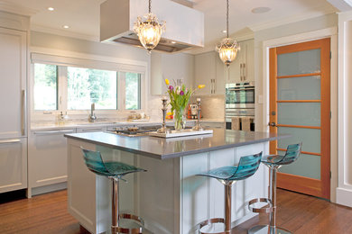 Example of a mid-sized transitional l-shaped dark wood floor eat-in kitchen design in Vancouver with an undermount sink, recessed-panel cabinets, white cabinets, gray backsplash, matchstick tile backsplash, paneled appliances and an island