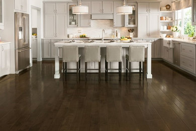 Inspiration for a mid-sized timeless u-shaped dark wood floor open concept kitchen remodel in Boston with shaker cabinets, beige cabinets, stainless steel appliances and an island