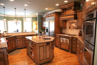 Large u-shaped medium tone wood floor eat-in kitchen photo in Other with an undermount sink, raised-panel cabinets, white cabinets, granite countertops, beige backsplash, subway tile backsplash, stainless steel appliances and a peninsula