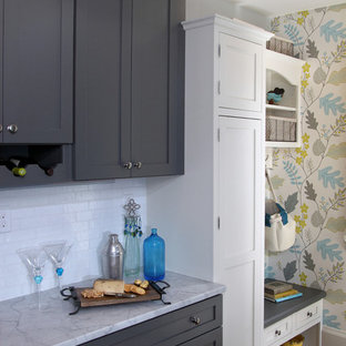 Mid-sized transitional eat-in kitchen designs - Inspiration for a mid-sized transitional u-shaped dark wood floor and brown floor eat-in kitchen remodel in Milwaukee with a farmhouse sink, shaker cabinets, gray cabinets, white backsplash, subway tile backsplash, stainless steel appliances, quartzite countertops, a peninsula and white countertops