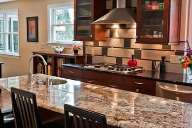 Example of a light wood floor eat-in kitchen design in Other with a drop-in sink, flat-panel cabinets, dark wood cabinets, granite countertops, stainless steel appliances and an island