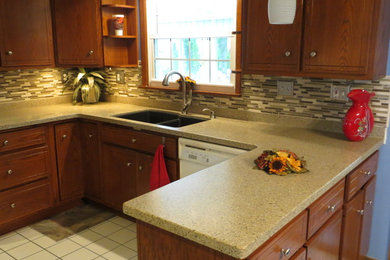 Eat-in kitchen - mid-sized transitional u-shaped ceramic tile and white floor eat-in kitchen idea in Other with a double-bowl sink, flat-panel cabinets, dark wood cabinets, multicolored backsplash, matchstick tile backsplash, a peninsula, solid surface countertops and stainless steel appliances